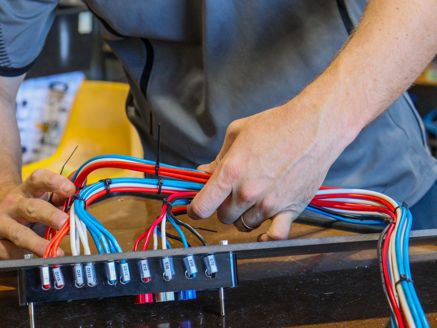 Lacing a wiring loom into a custom switchboard in the Geraldton workshop